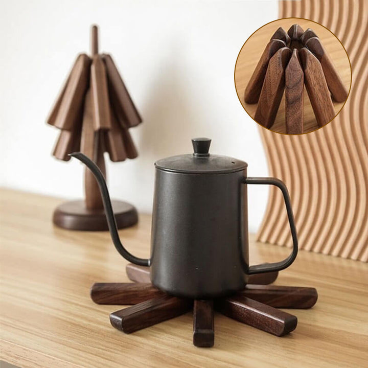 Black walnut wood table mat with a black kettle and a folded slats close-up, another view