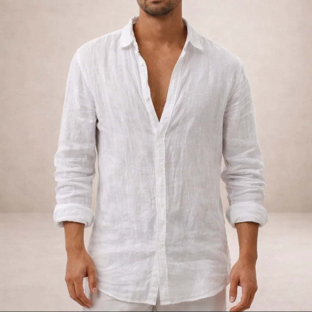 Front view of the white linen shirt on a model, collar open, sleeves rolled to the forearms.
