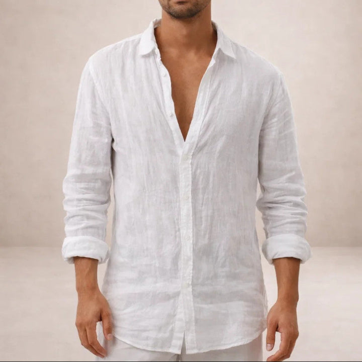 Front view of the white linen shirt on a model, collar open, sleeves rolled to the forearms.