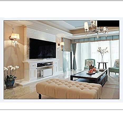 Sample camera view of a bright living room with a wall-mounted TV, tufted ottoman, coffee table and chandelier. 5