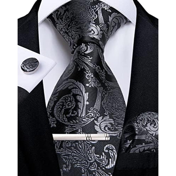 Black and gold paisley tie set with matching cufflink, pocket square and silver tie clip.