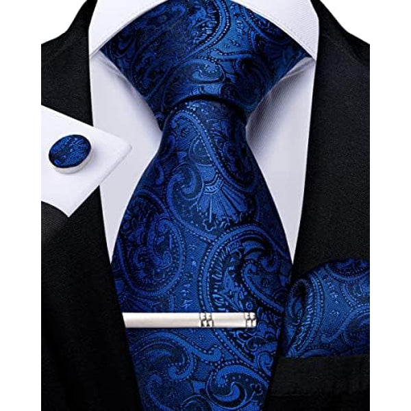 Deep royal blue paisley tie set with navy details, shown with matching cufflink, pocket square and silver tie clip.