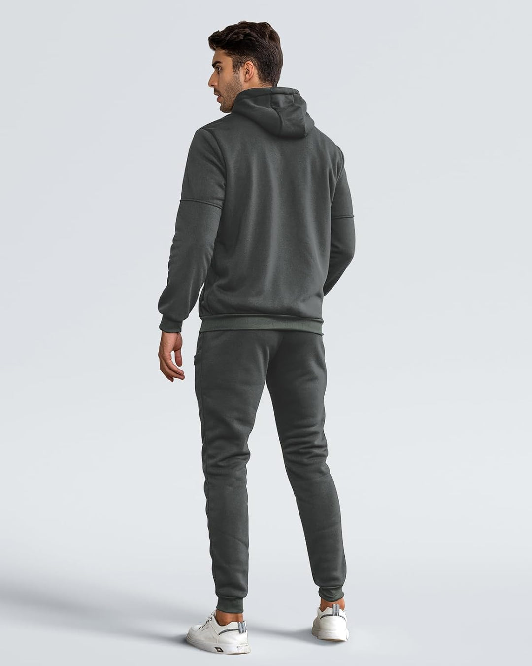 Back view of model wearing the dark gray hoodie and joggers, showing the hood and ribbed hem 10