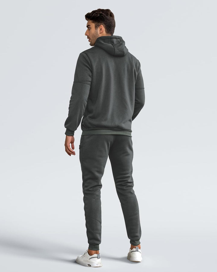 Back view of model wearing the dark gray hoodie and joggers, showing the hood and ribbed hem 10