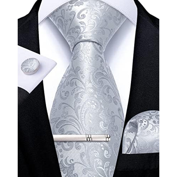 Silver-gray tonal paisley tie set on a white shirt, with matching cufflink, pocket square and silver tie clip.