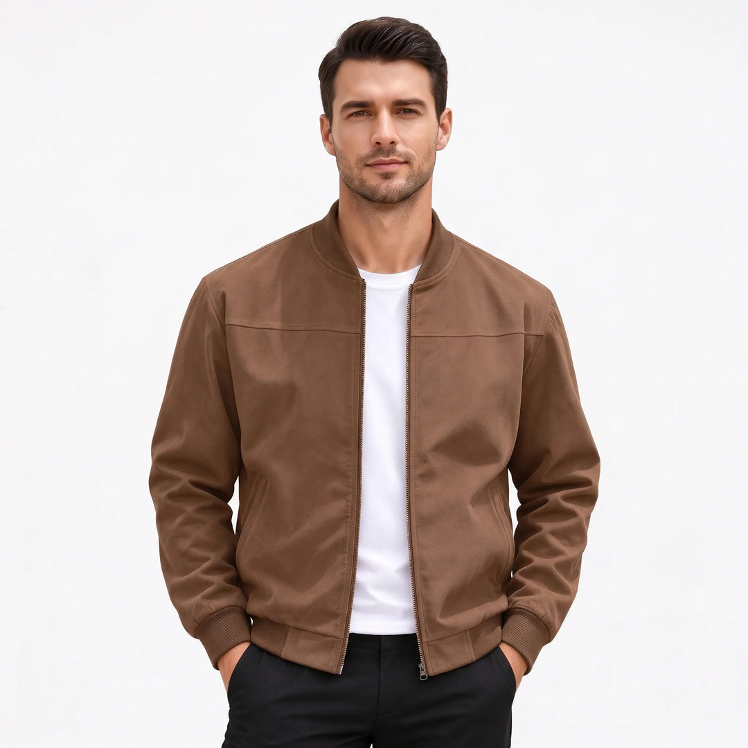Studio shot of a man in the brown bomber jacket, hands in black pants pockets 52