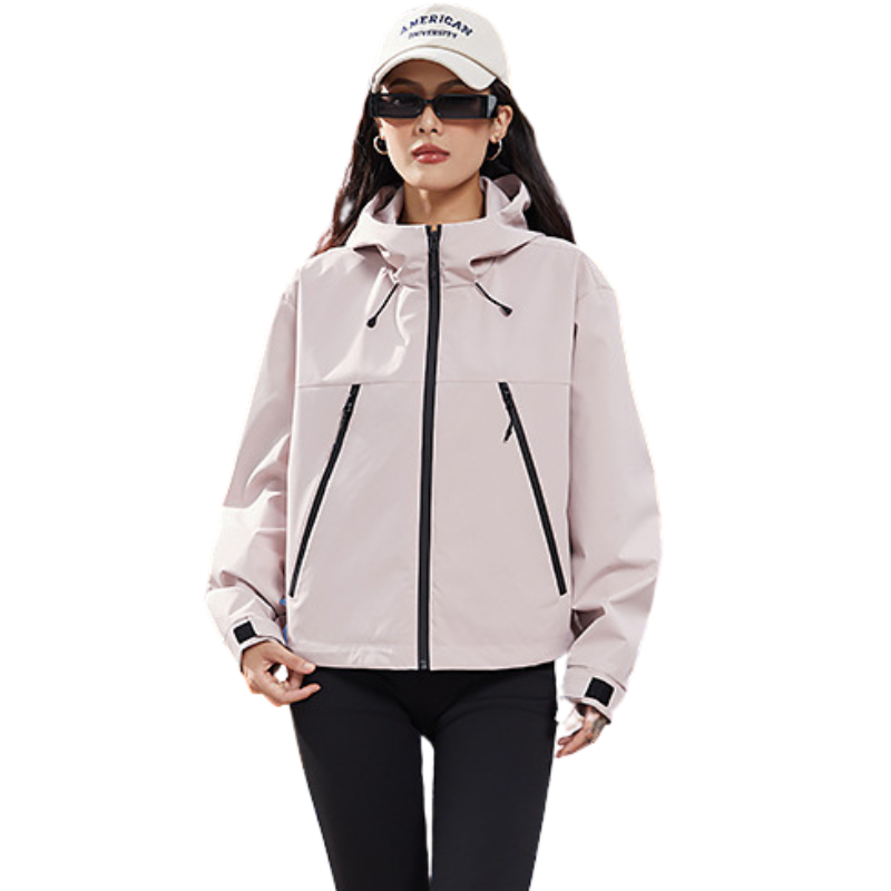 Front view of the light pink hooded jacket on a model with a white cap and narrow sunglasses, cuff tabs visible. 9