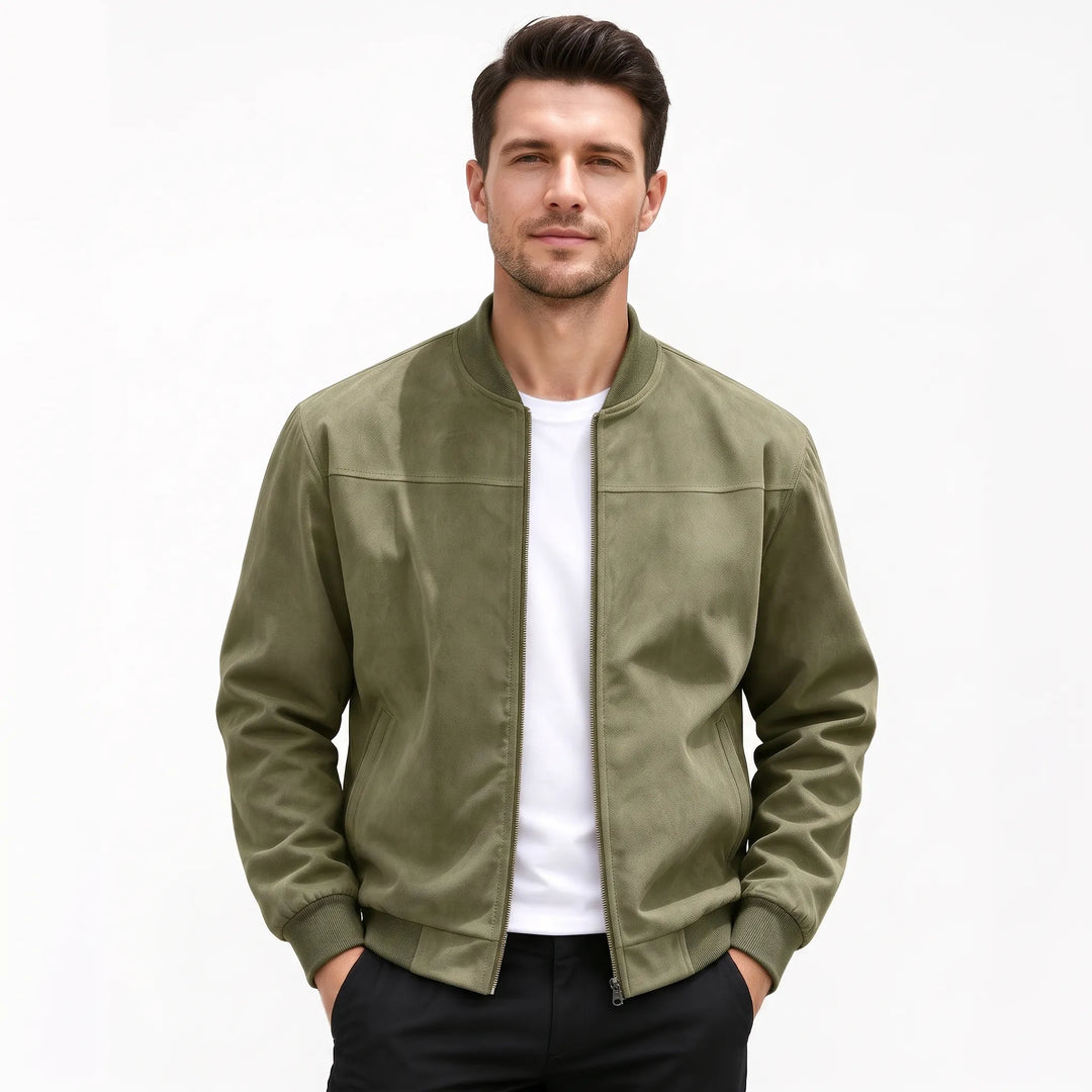 Studio shot of a man in the olive green bomber jacket, hands in black pants pockets 53
