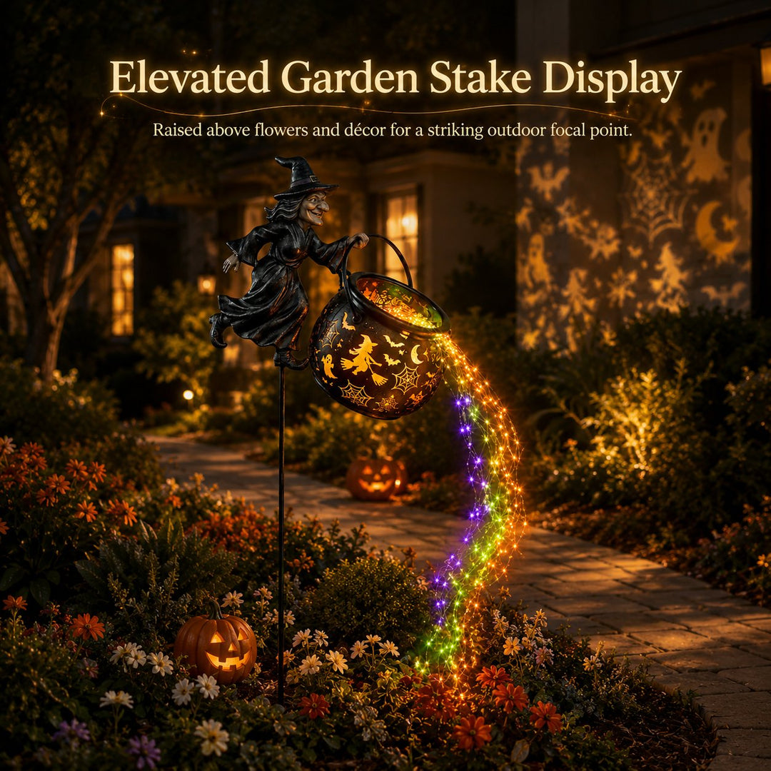 Another view of the witch light raised on its tall stake beside a stone garden path, surrounded by flowers and glowing jack-o'-lanterns.