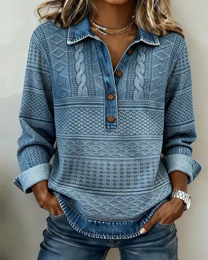 Women's blue patterned sweatshirt with shirt collar, button front, and cuff detail.