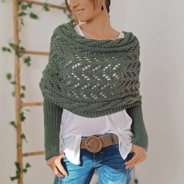 Olive green wrap with openwork lace pattern and ribbed sleeves, worn over a white top with a woven belt. 13