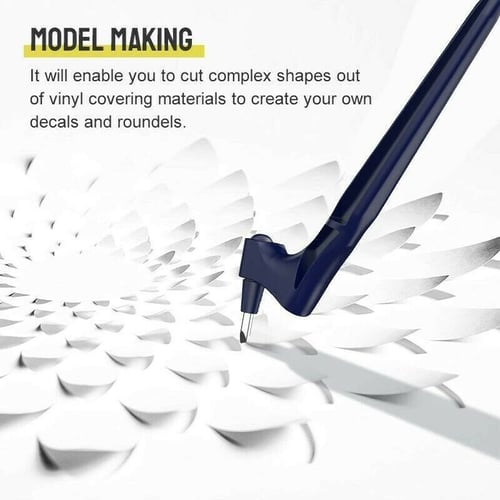 Navy knife tip cutting through a swirl of white paper petals, illustrating intricate shape and decal cutting. 6