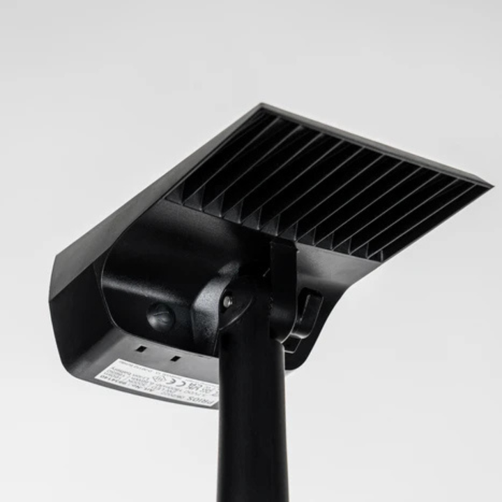 Underside of the spotlight head showing the ribbed back, the pivoting joint on the stake and a small label. 5