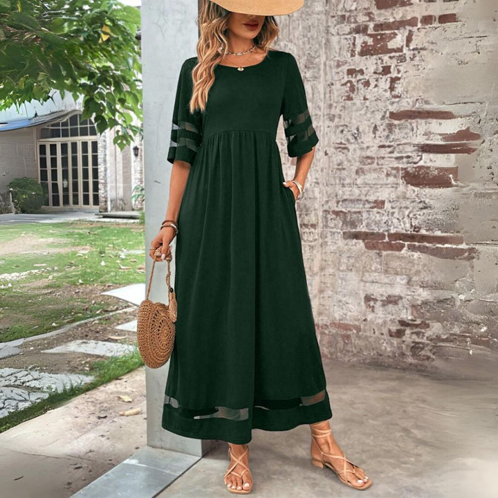 Dark green version of the maxi dress with sheer-striped sleeves and hem, styled with a straw hat and woven round bag. 6