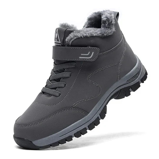 Dark gray high-top boot with fleece lining, strap, laces and a black lugged sole 7