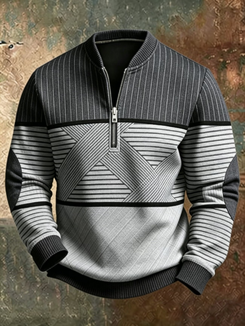 Charcoal and light gray half-zip sweater with a ribbed stand collar, crisscross striped chest panel and dark elbow patches.