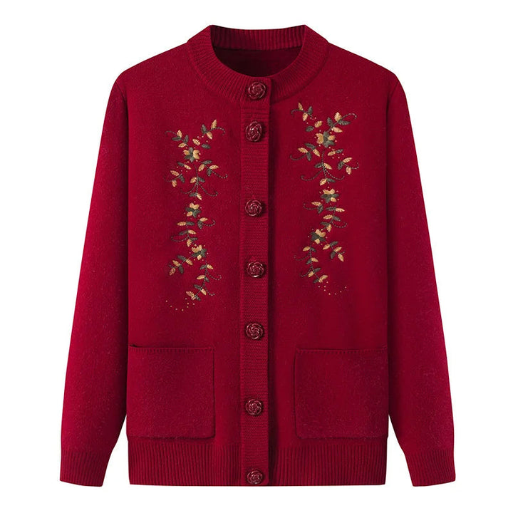 Rote Damenstrickjacke mit Blumenstickerei, Knopfleiste, Taschen, Herbstmode.