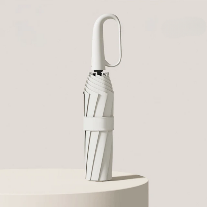 Closed folding umbrella in White with an oval hook handle and fabric strap.