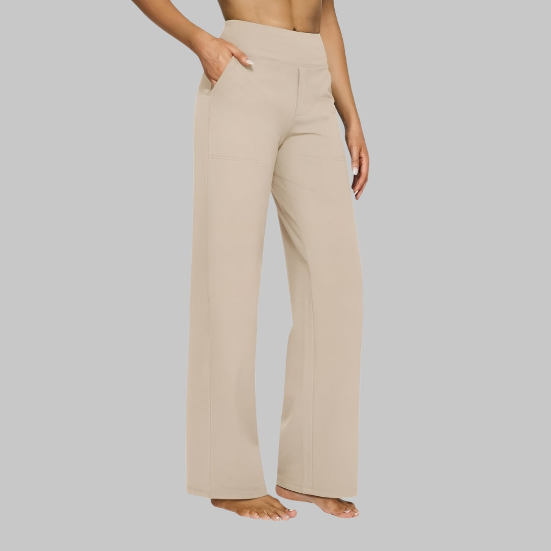 Women's light beige high-waist straight-leg pants on a model, three-quarter side view with a hand in the pocket.