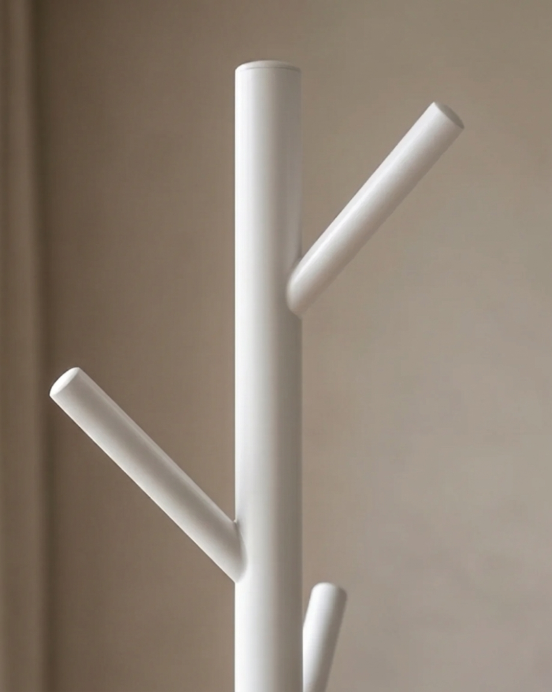 Close-up of the white rack's top, showing the rounded pole end and two angled hook branches 5