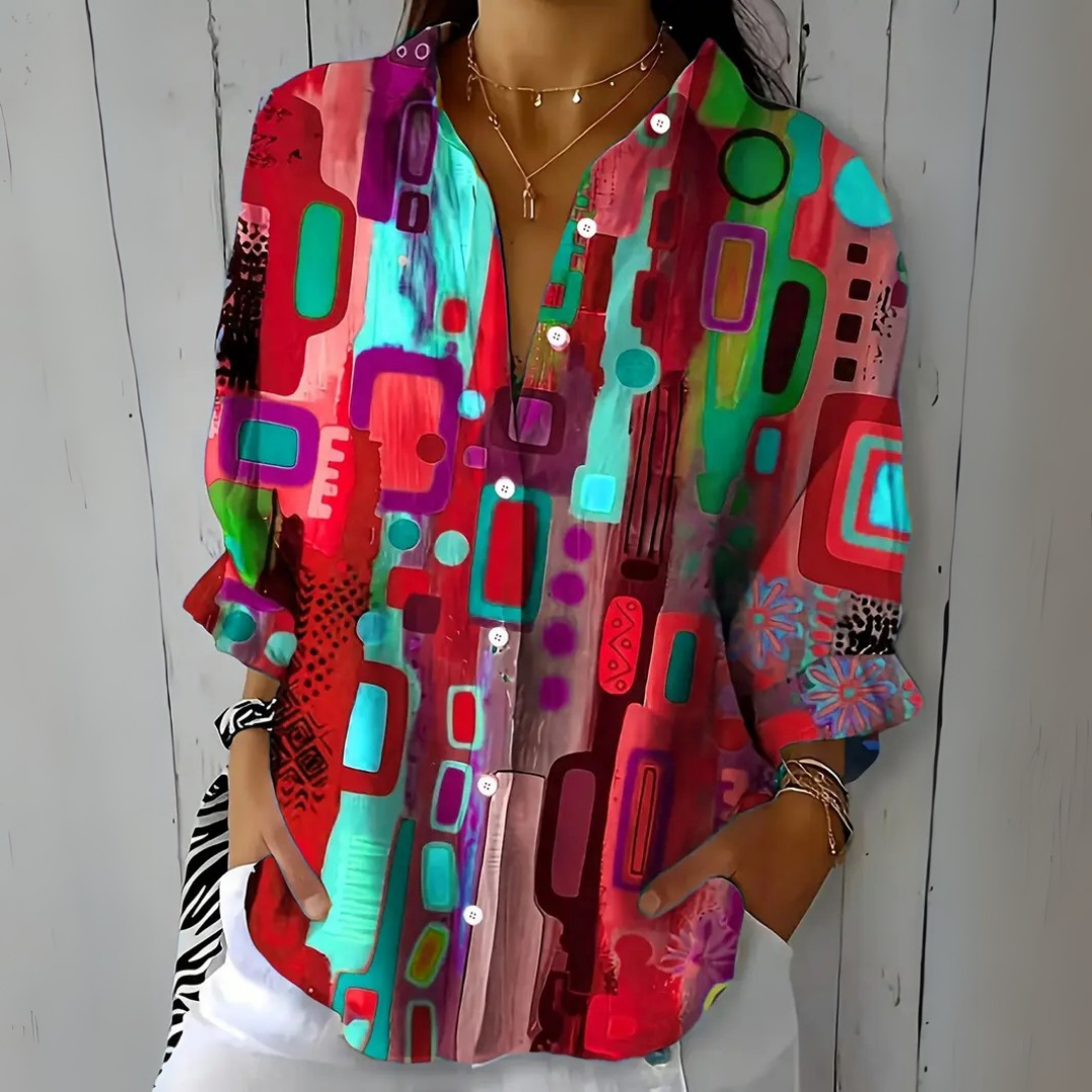 Front view of the red, pink and turquoise colorway of the patterned blouse.