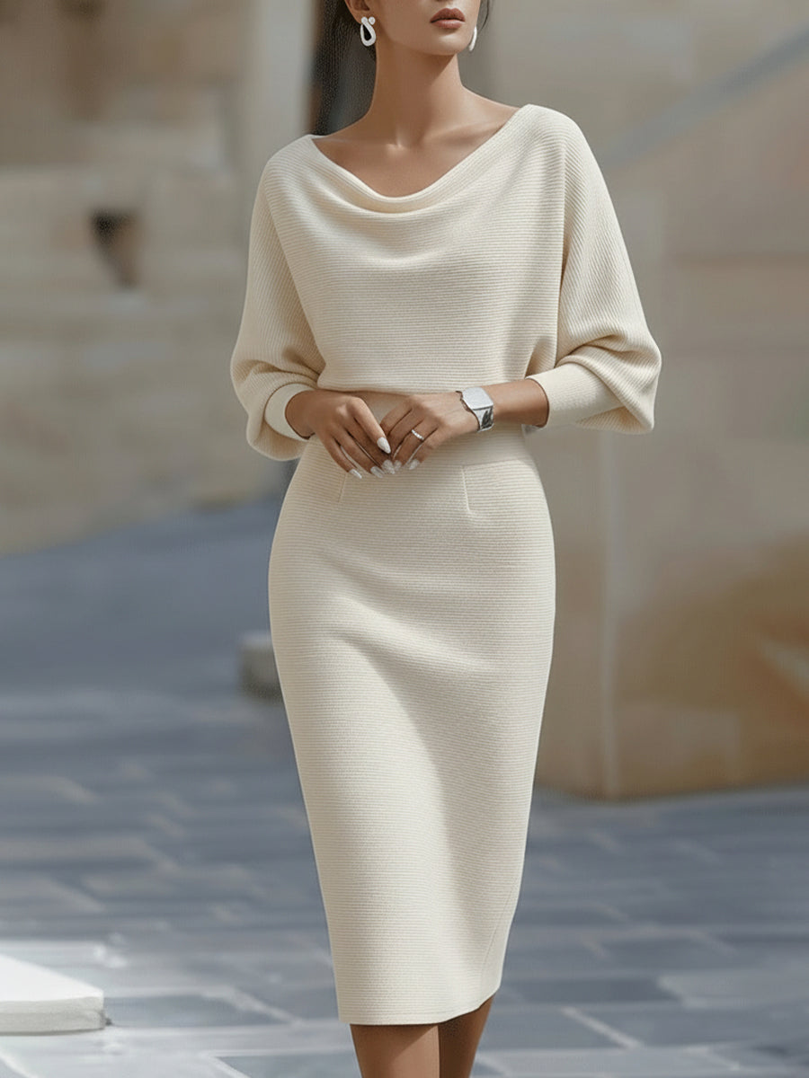 Model wearing the cream ribbed knit dress with draped neckline and three-quarter sleeves, front view 3