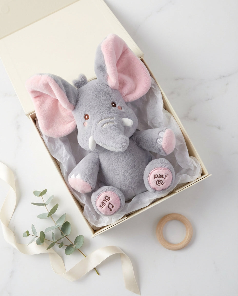 Another view of PeekaBuddy The Giggle Elephant Interactive Peekaboo Plush in an open cream gift box.