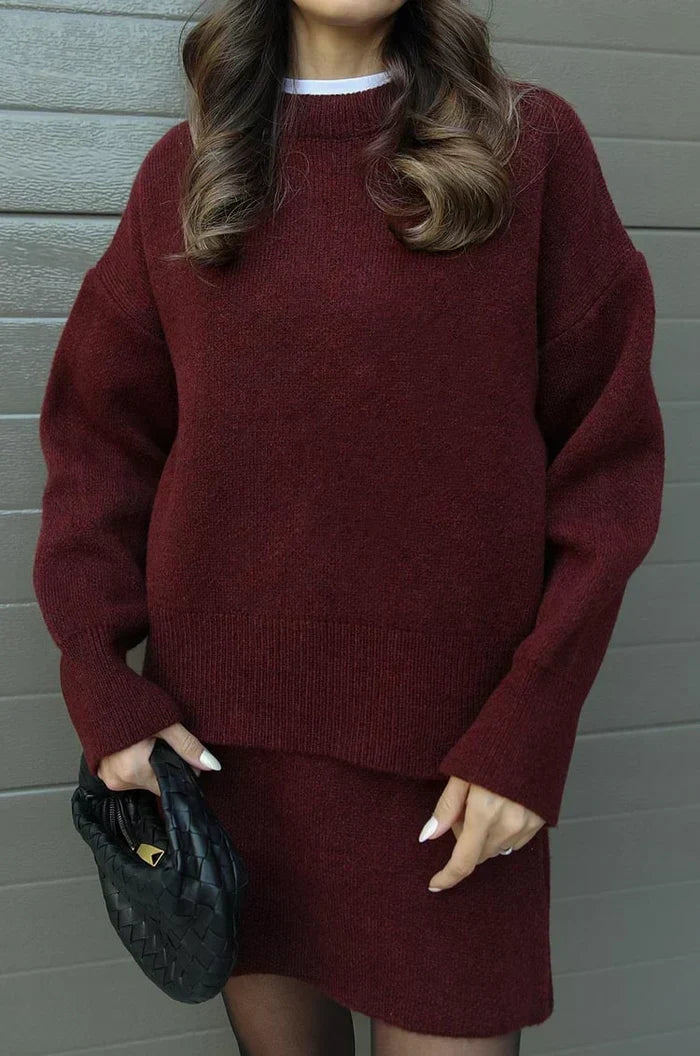 Close-up of the burgundy sweater's ribbed hem and cuffs with the flared skirt below 4