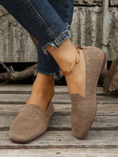 Brown mesh knit slip-on flats with a gold chain anklet, another view.
