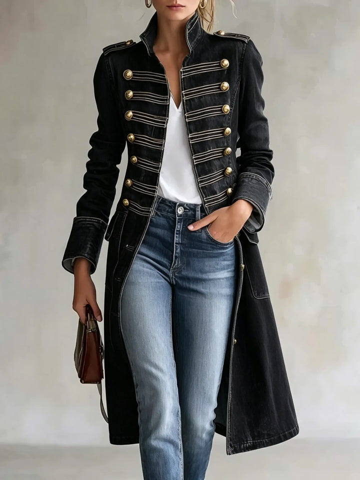 Black denim version of the double-breasted coat with gold buttons, silver braided trim and epaulettes, worn over a white top and jeans. 8