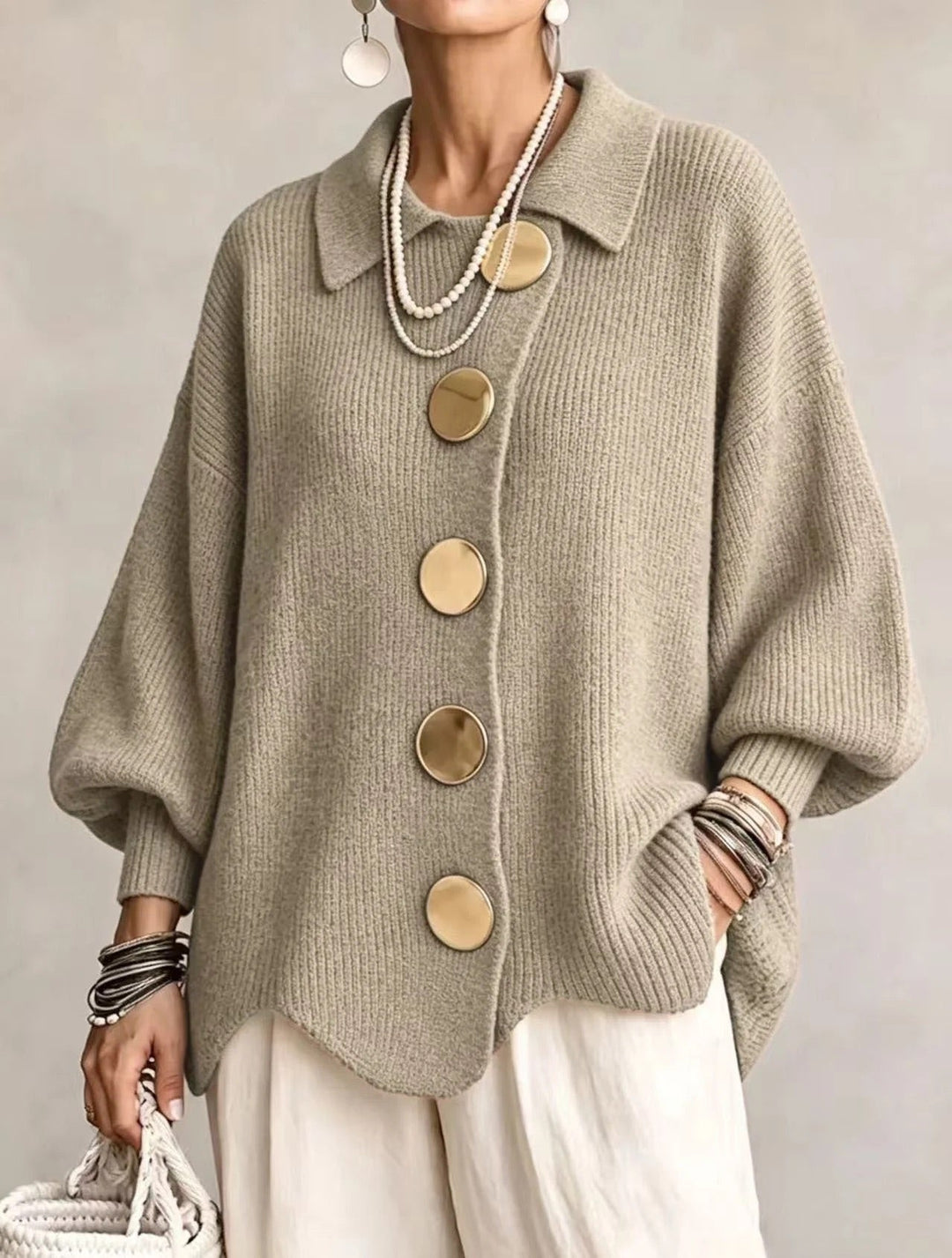 Sage khaki ribbed cardigan on a model with gold buttons, pointed collar, balloon sleeves and scalloped hem. 17