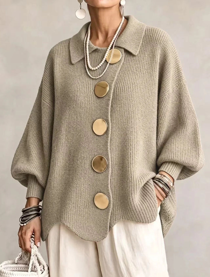 Sage khaki ribbed cardigan on a model with gold buttons, pointed collar, balloon sleeves and scalloped hem. 17