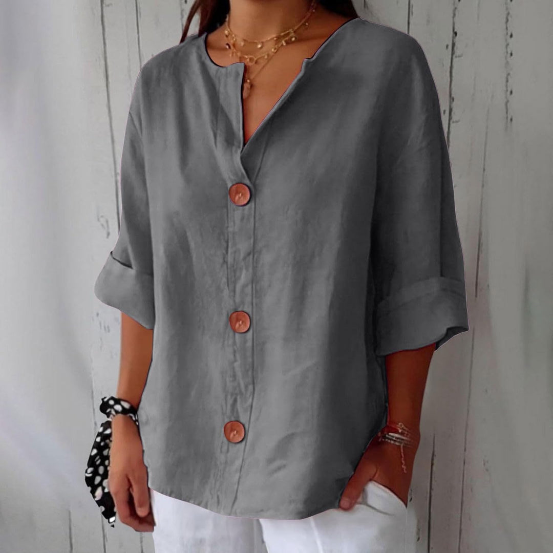 Olivia loose linen blouse in gray with a notched V-neck, three brown buttons and cuffed half sleeves.