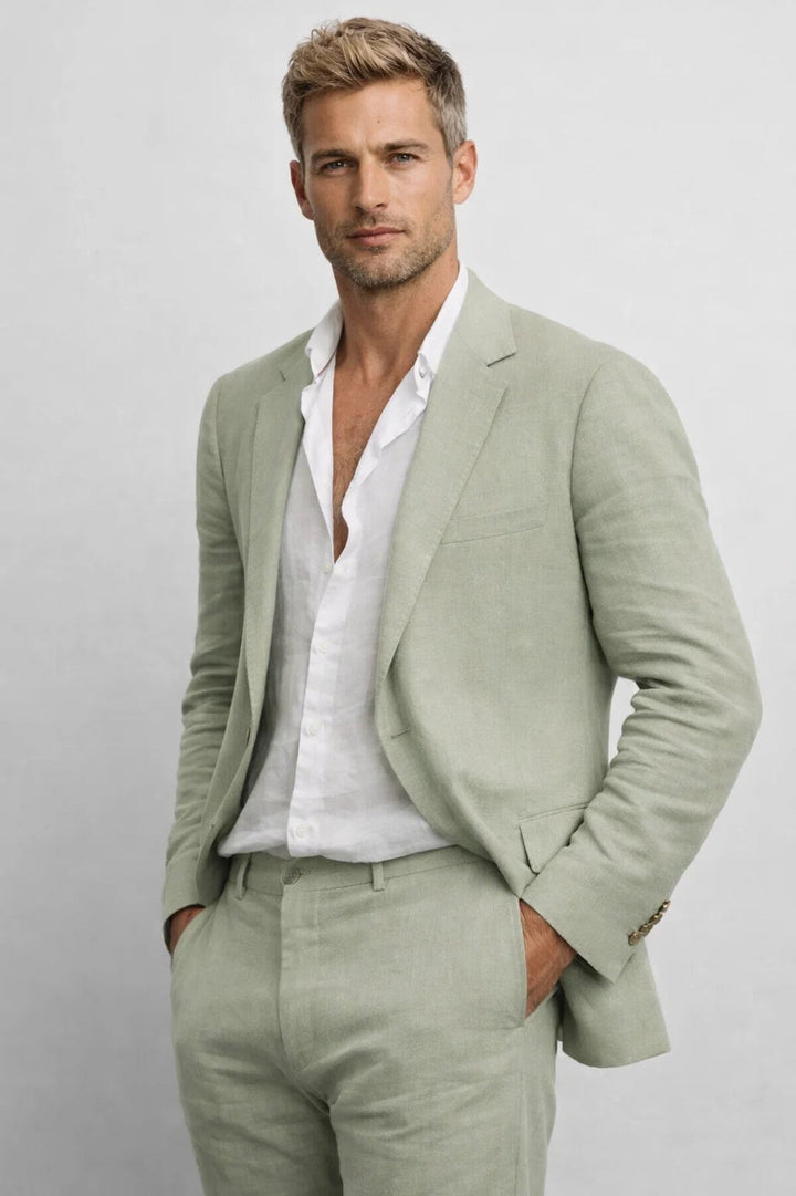 Men's linen suit in sage green with an open-collar white shirt, shown from the waist up.