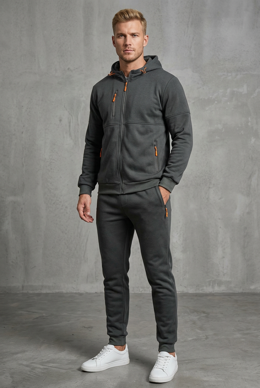 Front view of a man in a dark gray zip hoodie and joggers with orange zipper pulls 4