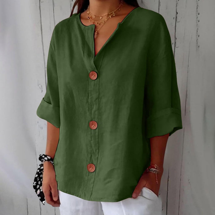Olivia loose linen blouse in olive green with a notched V-neck, three brown buttons and cuffed half sleeves.