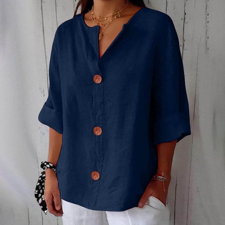 Olivia loose linen blouse in navy blue with a notched V-neck, three large buttons and cuffed half sleeves.