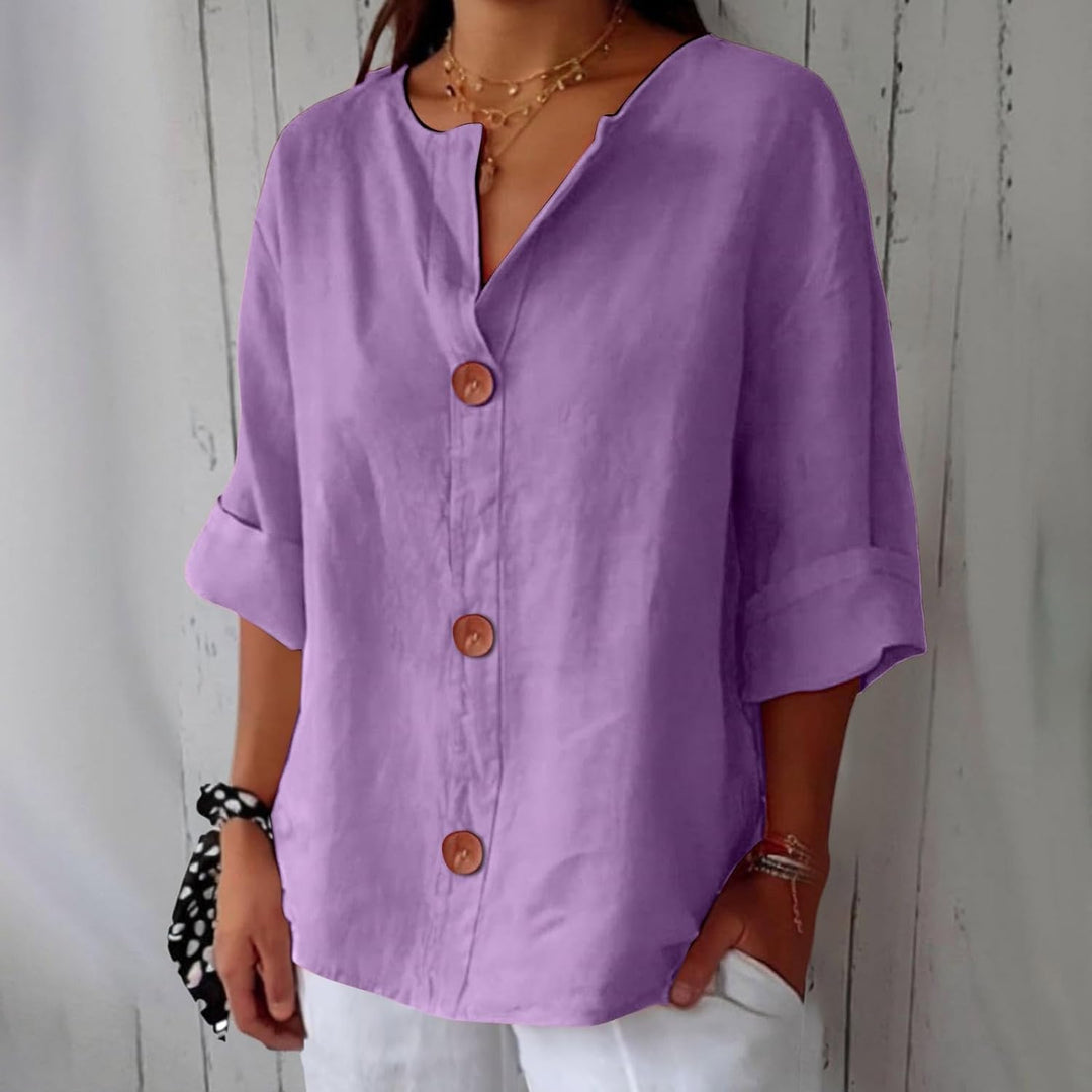 Olivia loose linen blouse in lilac purple with a notched V-neck, three brown buttons and cuffed half sleeves.