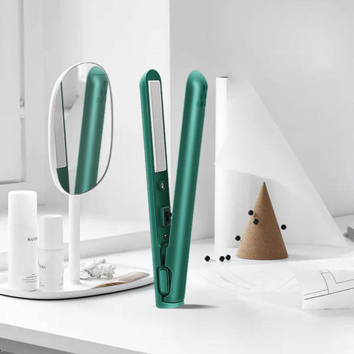 Open green mini straightener standing on a white vanity beside a round mirror and white bottles 2