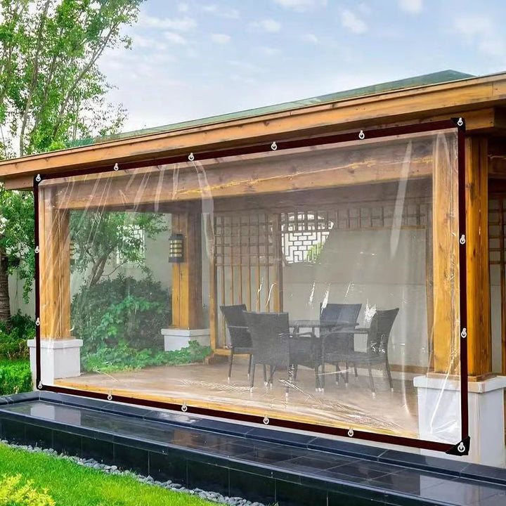 Clear tarp hung across the open side of a wooden garden pavilion.