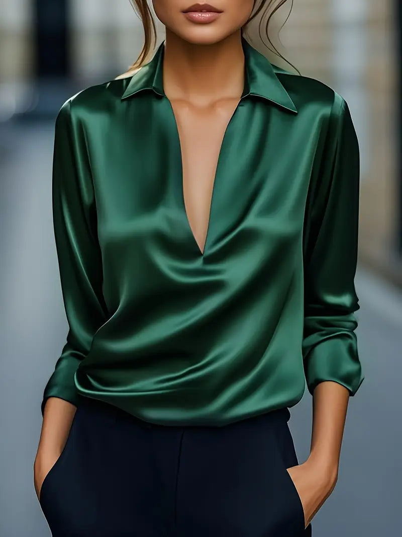 Model wearing the long-sleeve satin blouse in emerald green with a deep V-neck and collar.