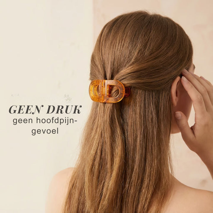Back view of a woman wearing an amber Flat Grip Magnetic Hair Clip low on a half-up style.