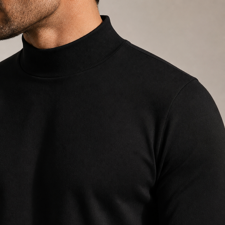 Close-up detail of the ribbed high collar and fitted sleeve of the black tee.
