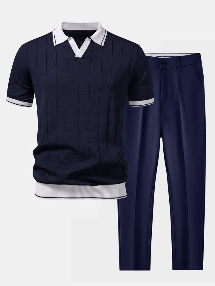 Flat lay of a navy ribbed knit polo with white contrast trim beside matching navy tapered pants.