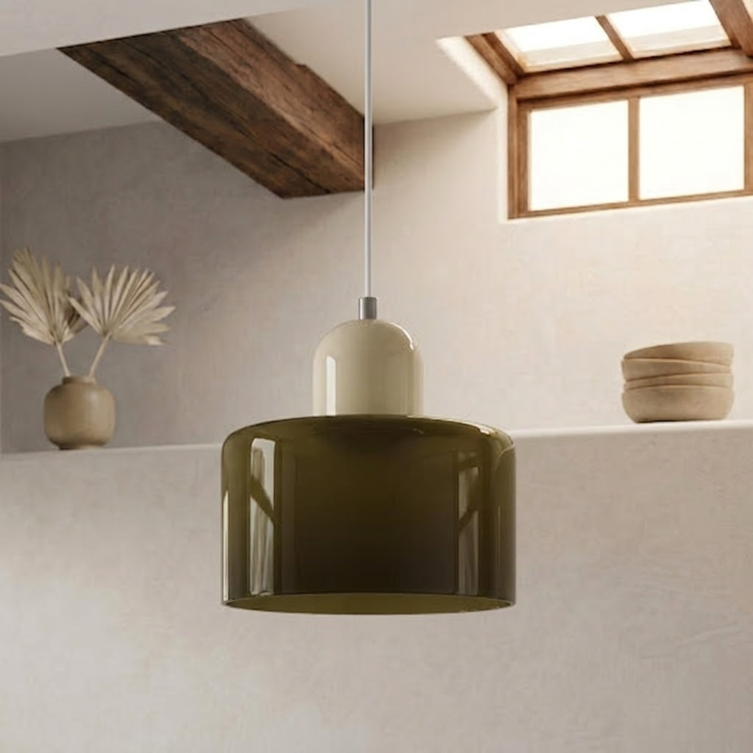 Dark olive glass drum shade with a cream cap, hanging from a white cord beside a shelf with a vase and bowls. 12