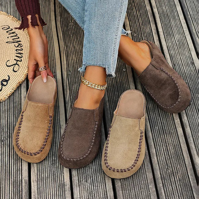 Brown leather slip-on sandals in tan and dark brown, flat lay with insoles visible.