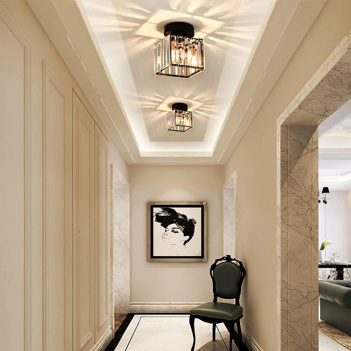 Black square ceiling light in a long hallway with marble archways.