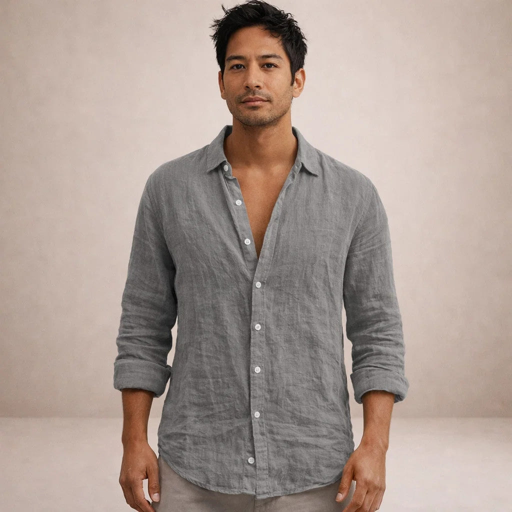 Model facing the camera in the gray linen shirt, collar open, sleeves rolled, softly wrinkled fabric.