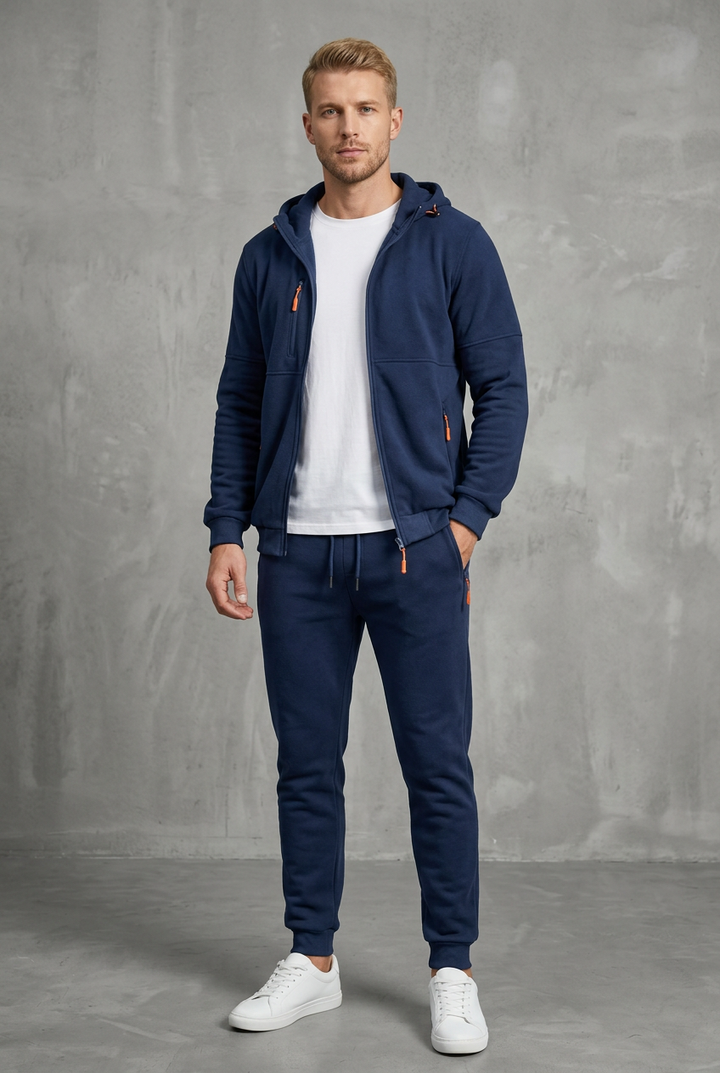 Front view of a navy blue hooded zip jacket and jogger pants worn over a white tee 2