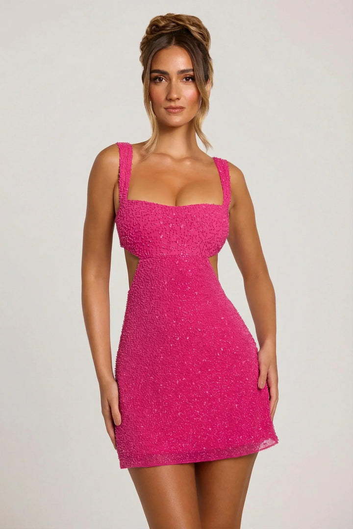 Pink embellished mini dress with square straps and side cut-outs.